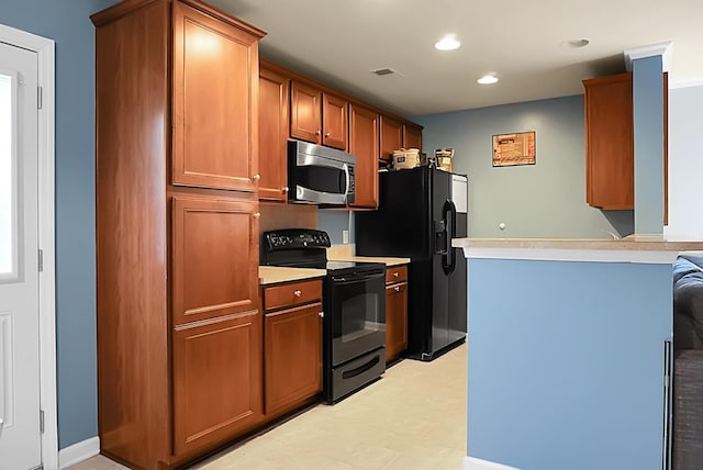 kitchen featuring brown cabinetry, black appliances, light countertops, a peninsula, and recessed lighting