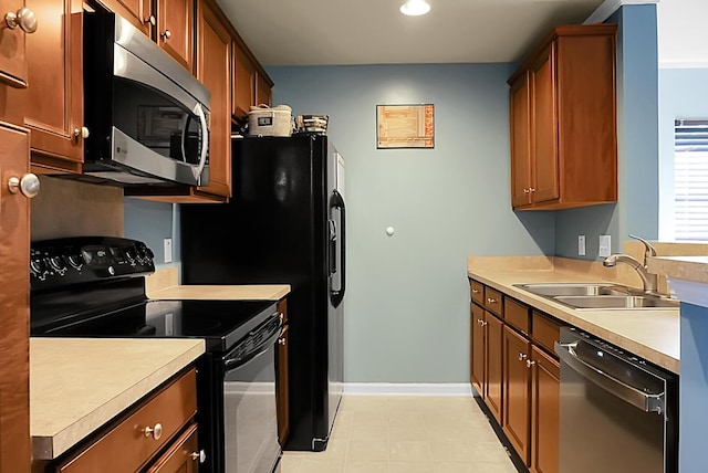 kitchen with light countertops, a sink, recessed lighting, and appliances with stainless steel finishes