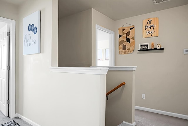 staircase featuring carpet flooring and baseboards
