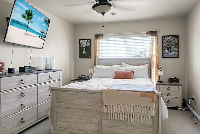 bedroom featuring light carpet, a ceiling fan, and visible vents