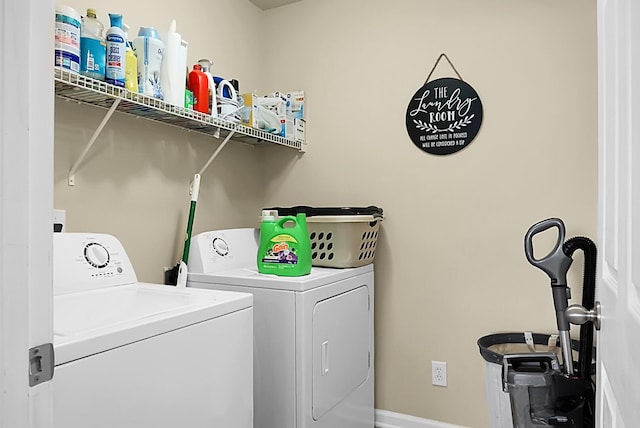 laundry room featuring baseboards, independent washer and dryer, and laundry area