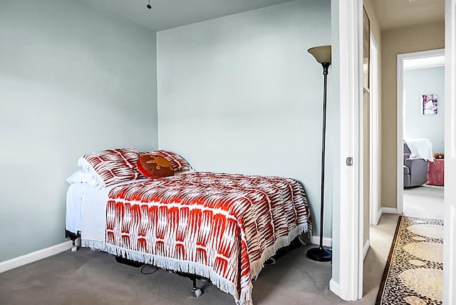 bedroom featuring carpet floors and baseboards