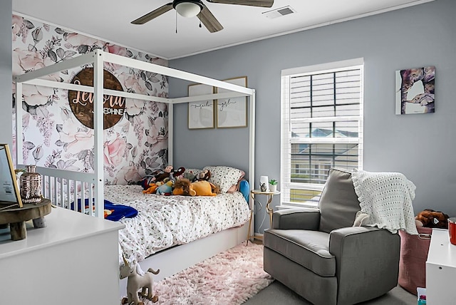 bedroom featuring a ceiling fan, visible vents, and ornamental molding
