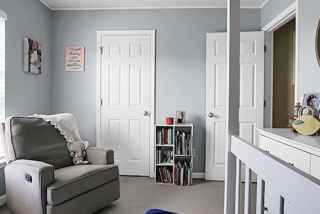 sitting room featuring carpet flooring and crown molding
