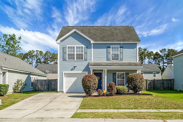 traditional-style home with an attached garage, fence, a front yard, and concrete driveway