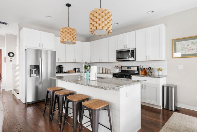 kitchen with decorative backsplash, stainless steel appliances, and dark wood-style flooring