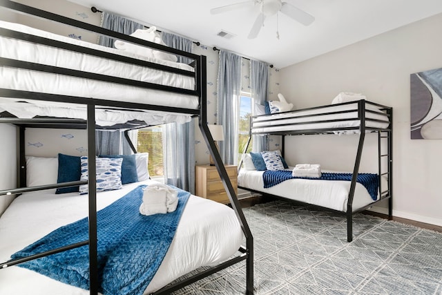 bedroom featuring visible vents, baseboards, and a ceiling fan