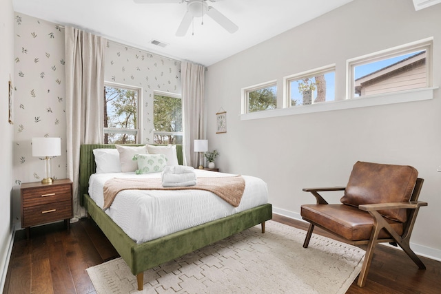 bedroom featuring visible vents, wallpapered walls, ceiling fan, baseboards, and dark wood finished floors