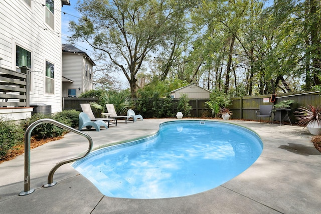 view of pool featuring a patio, a fenced backyard, and a fenced in pool