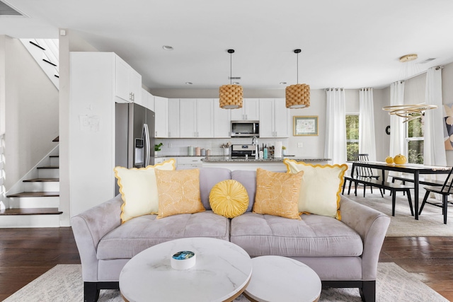 living room with stairs, recessed lighting, wood finished floors, and visible vents