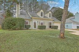 cape cod house with a front yard