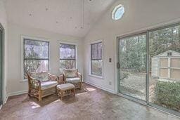 sunroom featuring vaulted ceiling