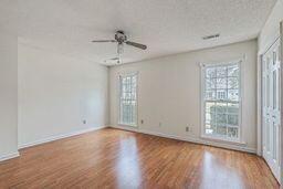 unfurnished room featuring baseboards, wood finished floors, and a ceiling fan