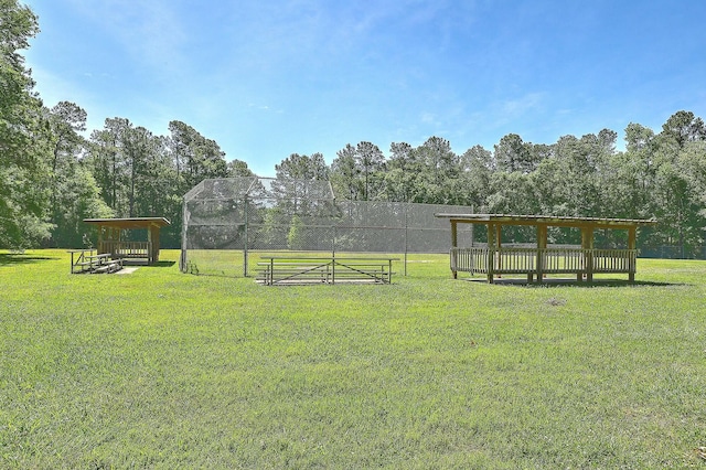 view of yard featuring a tennis court and fence