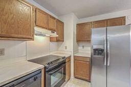 kitchen featuring under cabinet range hood, light countertops, black / electric stove, and stainless steel refrigerator with ice dispenser