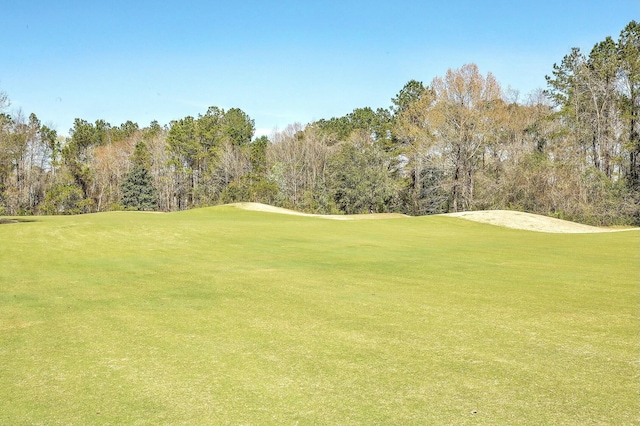 view of home's community featuring a yard and golf course view