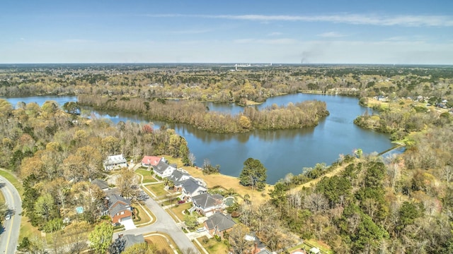 drone / aerial view with a wooded view and a water view