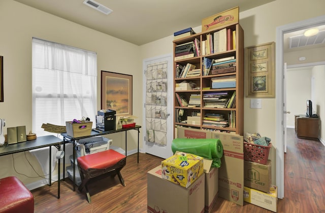 office space featuring dark wood-style flooring, visible vents, and baseboards