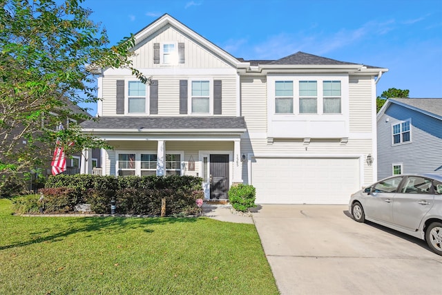 view of front of property with a front yard and a garage