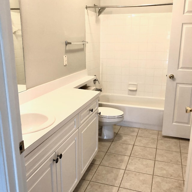 full bathroom featuring toilet, vanity, tile patterned floors, and tub / shower combination