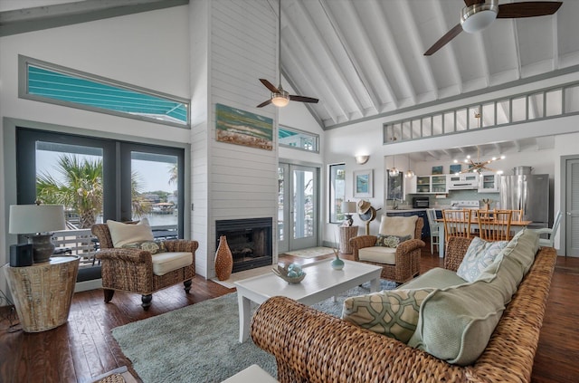2619 Buccaneer Rd, Isle Of Palms, SC 29451 - living area featuring a ceiling fan, high vaulted ceiling, dark wood finished floors, a large fireplace, and a chandelier