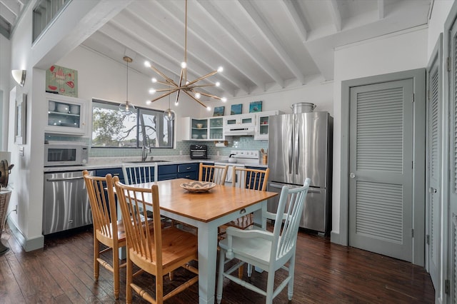 2619 Buccaneer Rd, Isle Of Palms, SC 29451 - dining room with a chandelier and dark wood-style flooring