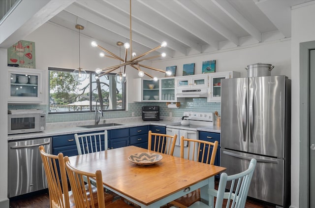 2619 Buccaneer Rd, Isle Of Palms, SC 29451 - kitchen with appliances with stainless steel finishes, blue cabinets, a sink, light countertops, and decorative backsplash