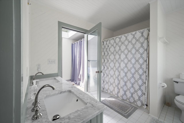2619 Buccaneer Rd, Isle Of Palms, SC 29451 - full bath featuring toilet, double vanity, a shower with shower curtain, and tile patterned flooring