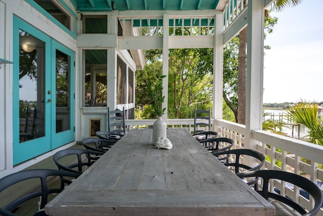 2619 Buccaneer Rd, Isle Of Palms, SC 29451 - wooden deck featuring french doors, outdoor dining space, and a water view