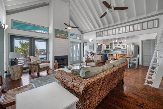 2619 Buccaneer Rd, Isle Of Palms, SC 29451 - living area with ceiling fan, high vaulted ceiling, a large fireplace, dark wood-style flooring, and beamed ceiling