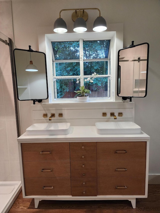 bathroom with vanity, a healthy amount of sunlight, and walk in shower