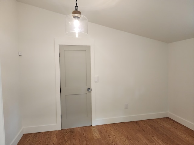 unfurnished room with hardwood / wood-style flooring