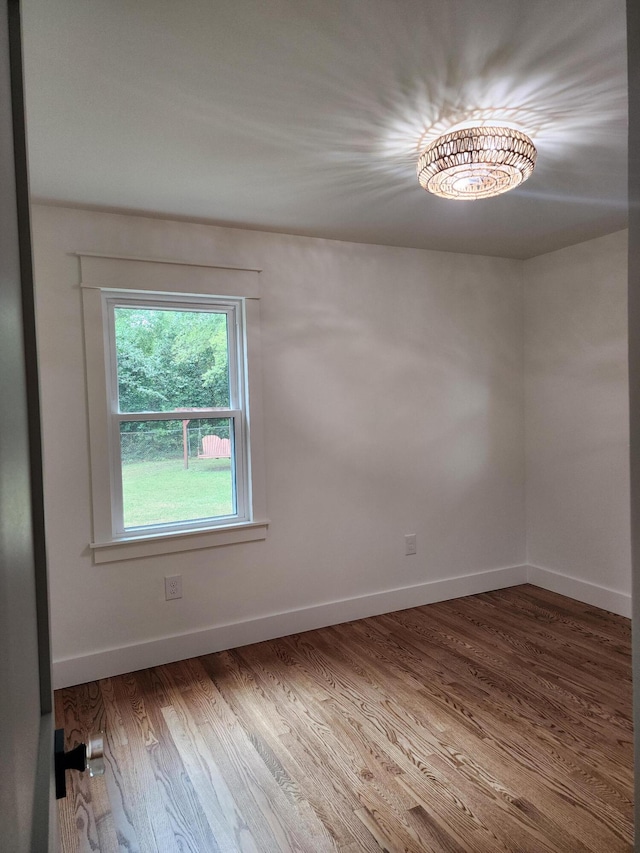 unfurnished room featuring hardwood / wood-style flooring