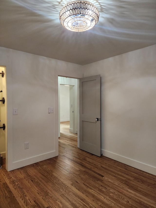 spare room featuring dark wood-type flooring