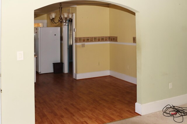 5286 Cameron Rd, Cameron, SC 29030 - empty room with baseboards, arched walkways, a chandelier, and wood finished floors