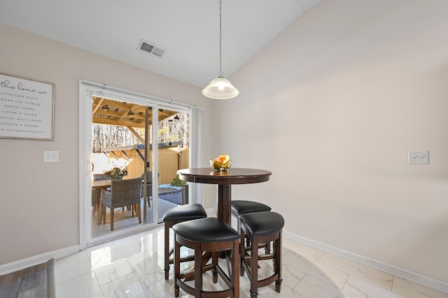 dining space with vaulted ceiling