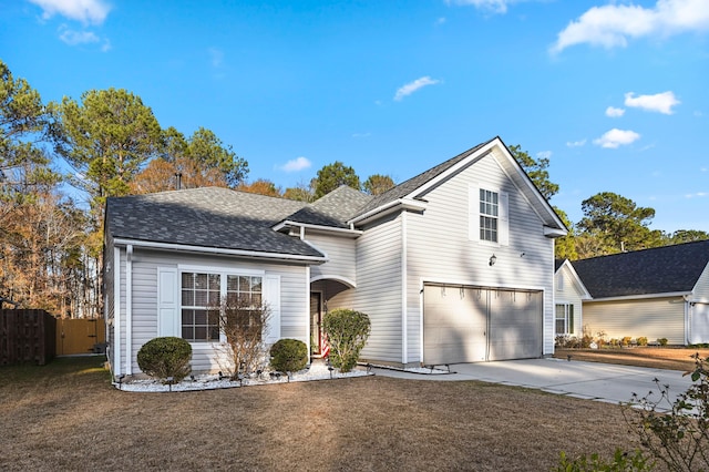 front facade featuring a garage and a front yard