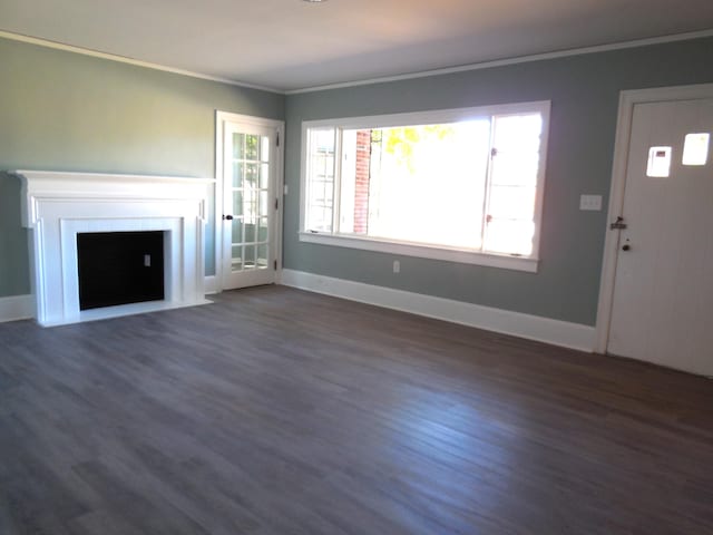 unfurnished living room featuring ornamental molding and dark hardwood / wood-style flooring