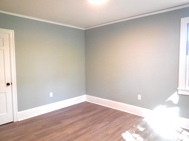 unfurnished room with ornamental molding and wood-type flooring