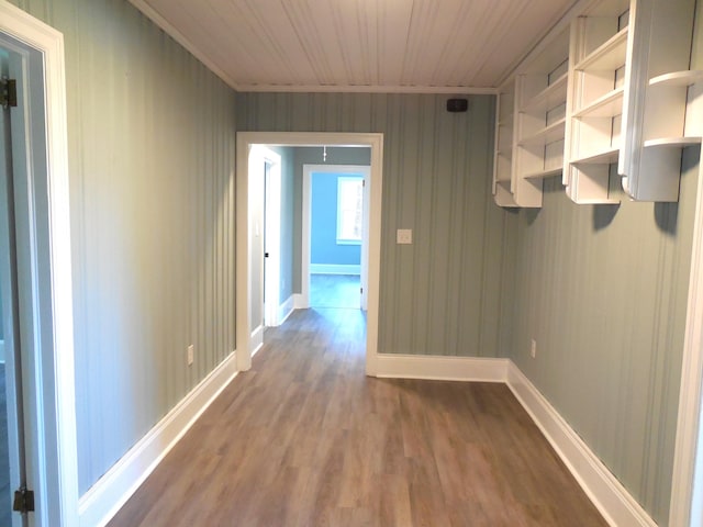 hallway featuring wood walls, wood-type flooring, and wooden ceiling