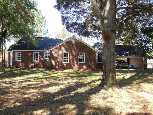 ranch-style house with a front yard and a carport