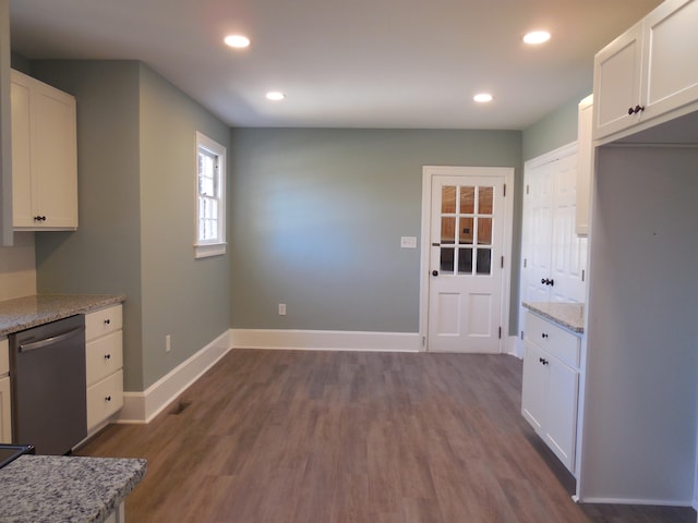 kitchen featuring white cabinetry, light stone counters, dark wood-type flooring, and dishwasher