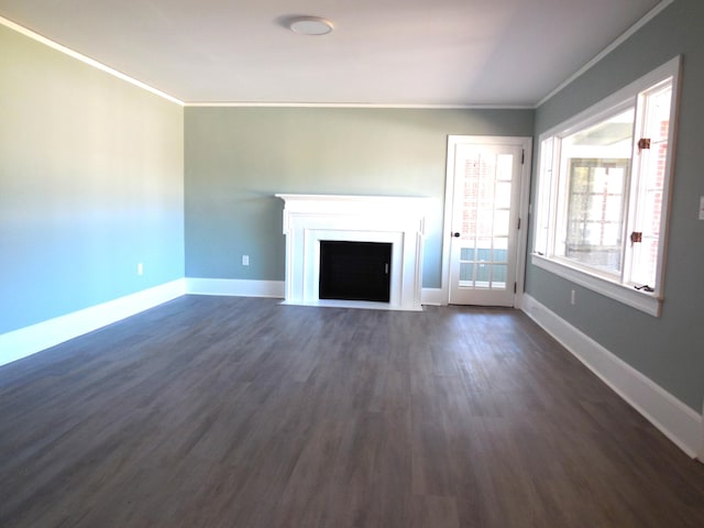 unfurnished living room featuring ornamental molding and dark hardwood / wood-style flooring