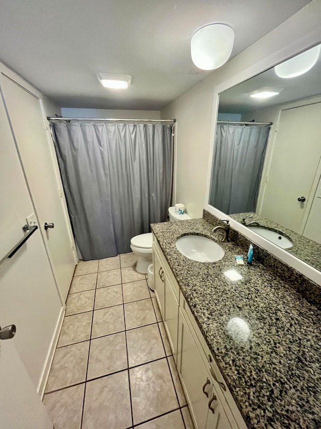 bathroom with vanity, tile patterned flooring, and toilet