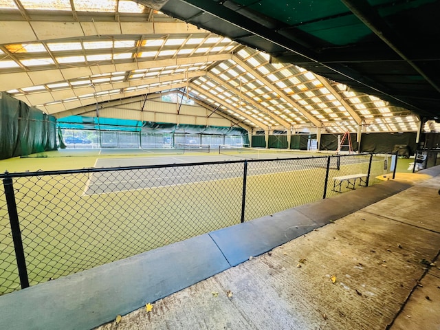 view of home's community featuring tennis court