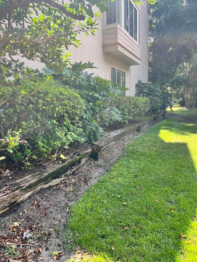 exterior space featuring a balcony and a yard