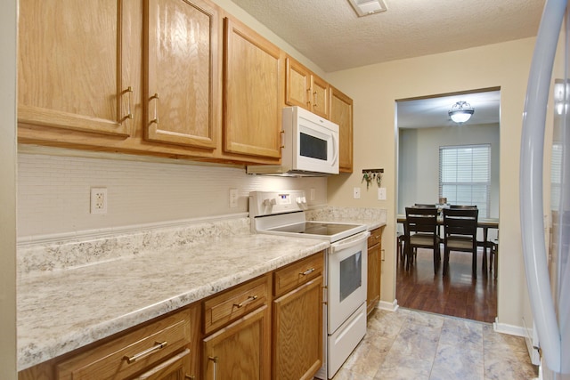 7896 Montview Rd, North Charleston, SC 29418 - kitchen with white appliances, light countertops, a textured ceiling, and baseboards