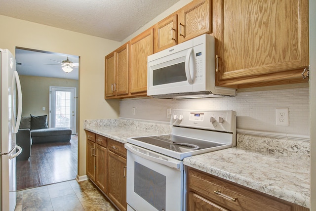 7896 Montview Rd, North Charleston, SC 29418 - kitchen featuring white appliances, ceiling fan, tasteful backsplash, and light countertops