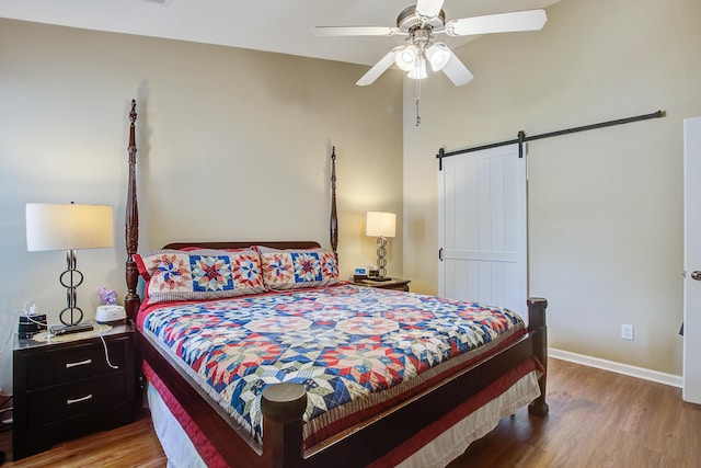 7896 Montview Rd, North Charleston, SC 29418 - bedroom featuring wood finished floors, a barn door, baseboards, and a ceiling fan