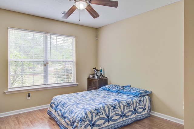7896 Montview Rd, North Charleston, SC 29418 - bedroom featuring multiple windows, baseboards, wood finished floors, and ceiling fan